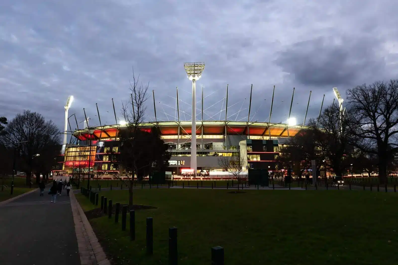 Cricket ground exterior at dusk showing stadium lights and venue used for cricket matches and training